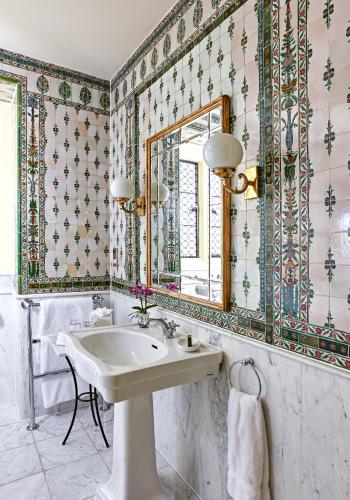 a bathroom with a sink and a mirror at Danesfield House Hotel And Spa in Marlow