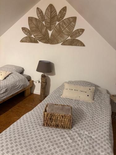 a bedroom with a bed with a plant on the wall at La maison du colombophile in Neuville-sur-Ailette