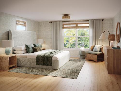 a bedroom with a large bed and a living room at Shore Haven Inn in Falmouth