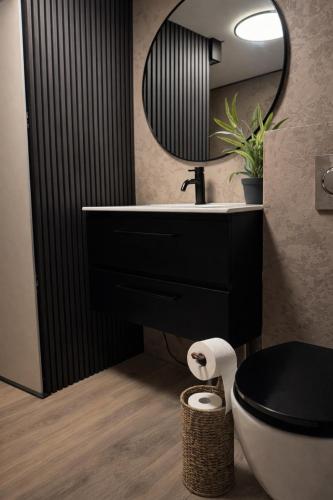 a bathroom with a black sink and a mirror at Slava Spa Relax House in Nakskov