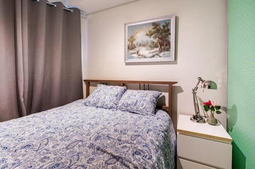 a bedroom with a bed and a picture on the wall at Apartment in the heart of Bergen in Bergen