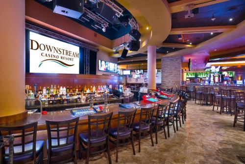 a bar with a row of bar stools at Downstream Casino Resort