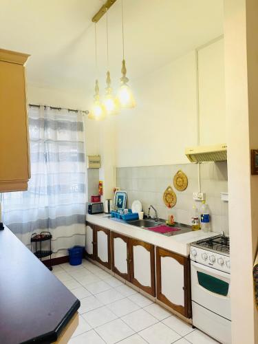 a kitchen with a sink and a stove at Pereybere Beach Home in Pereybere