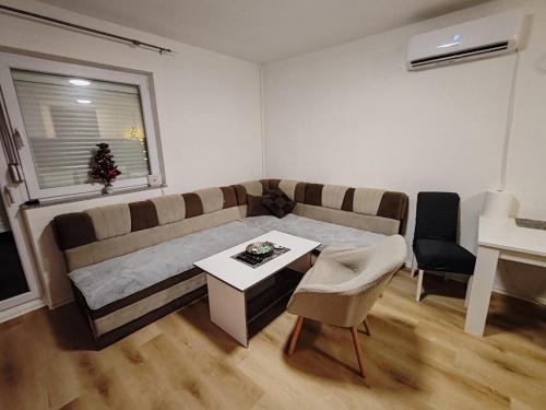 a living room with a couch and a table at Vikendica Katarina in Šipovo