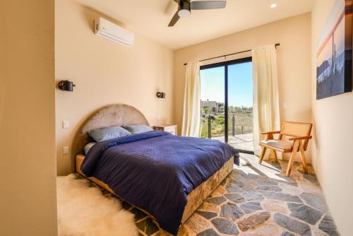 a bedroom with a bed and a large window at Casa Arroyo Pacific in Todos Santos
