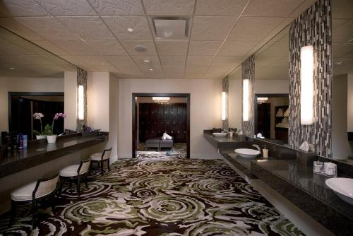 a bathroom with two sinks and a large carpet at Downstream Casino Resort in Loma Linda