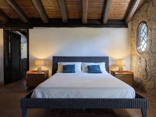 a bedroom with a large bed with two lamps at Azure Bay Chic Villa in Fontane Bianche