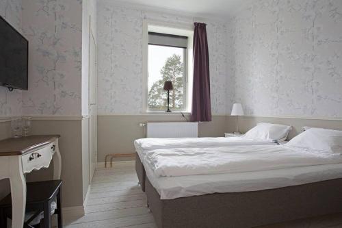 a bedroom with a large bed and a window at Norrfly Herrgård in Kilafors