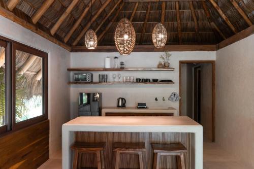 a kitchen with a island in a house at Hábitat Nandá in La Manzanilla
