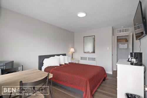 a hotel room with a bed with a red bedspread at The mint in Rock Springs
