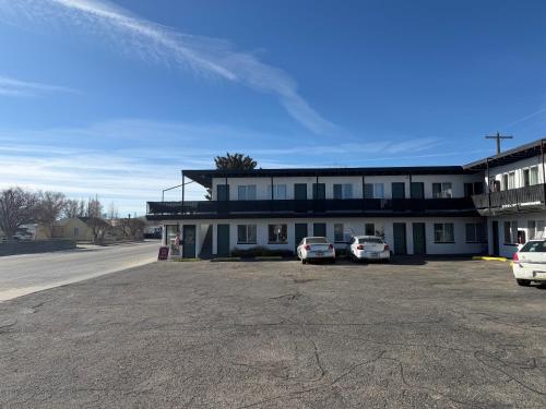 a building with two cars parked in a parking lot at The mint in Rock Springs