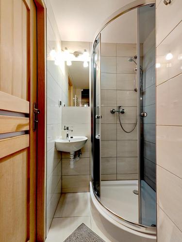 a bathroom with a shower and a sink at Noclegi Sarenka in Murzasichle