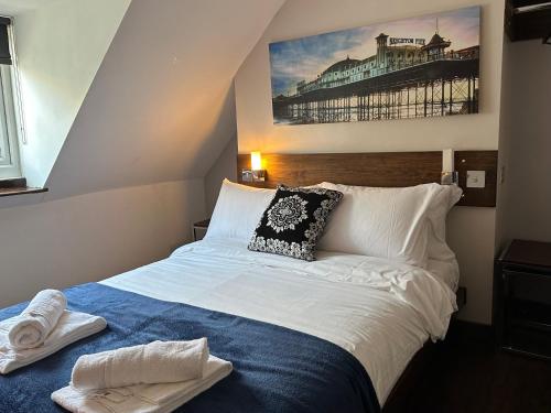 a bedroom with a bed with a picture on the wall at Guest And The City in Brighton & Hove