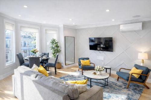 a living room with a couch and a table at Huge 2000 sqft Luxury & Stylish Condo minutes to New York in Jersey City