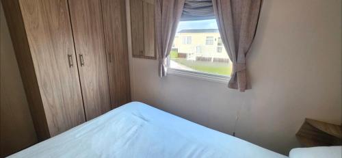 a bedroom with a bed and a window at Vanhalla in Heysham
