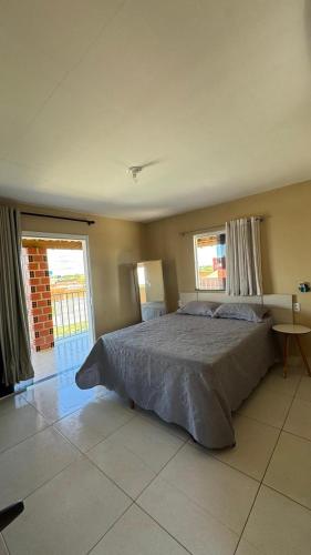 a bedroom with a large bed in a room at Dunas Exclusive in Santo Amaro