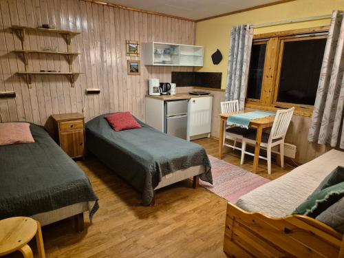 a small room with two beds and a kitchen at Alta River Camping in Alta