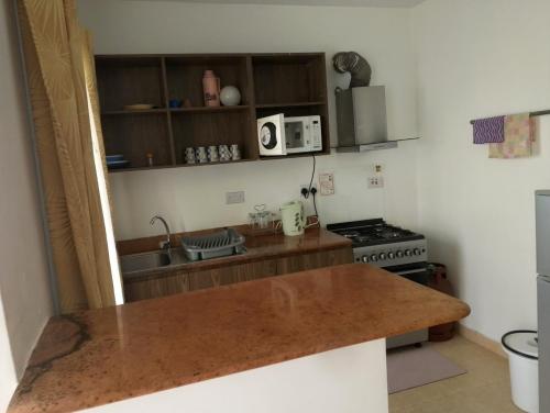 a kitchen with a counter top and a stove at Unity Homes Eldoret in Eldoret