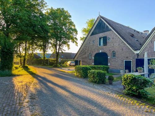 a brick house with a driveway in front of it at De Rheezer Kamer in Hardenberg