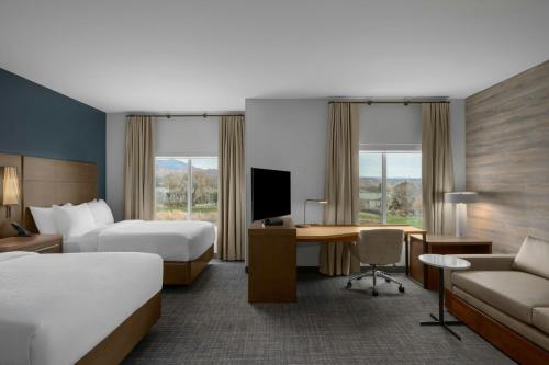 a hotel room with two beds and a desk at Residence Inn by Marriott St. George in Washington