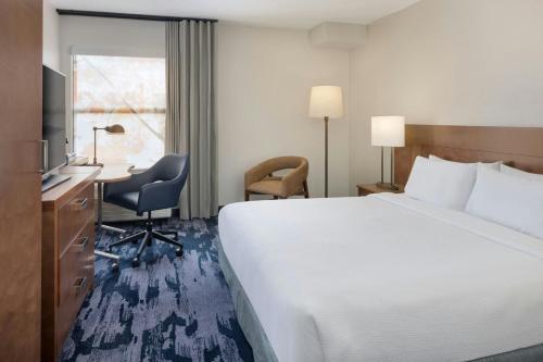 a hotel room with a large bed and a desk at Fairfield Inn Las Vegas Convention Center in Las Vegas