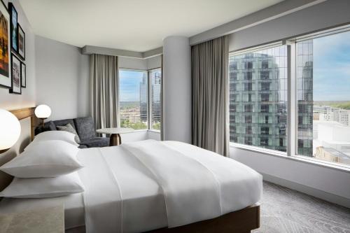 a hotel room with a large bed and a large window at JW Marriott Grand Rapids in Grand Rapids