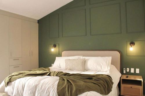 a bedroom with a large bed with green walls at Charming Suite Pool AC Location 10C in San Pablo