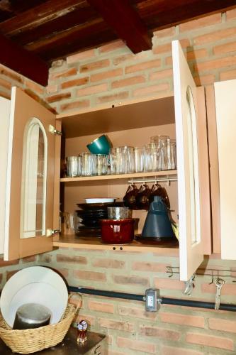a kitchen with some plates and glasses on shelves at Recanto do Amaral - Espaço de Lazer e Eventos in Betim