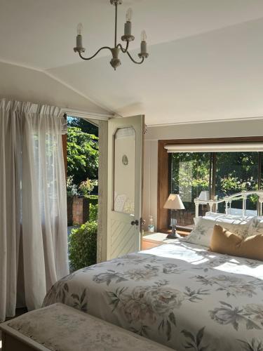a bedroom with a bed and a large window at McIvor Lodge in Invercargill