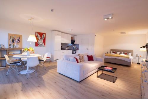 a living room with a couch and a table at Hermine, Black Forest Retreat, mit Sonnenterrasse in Baiersbronn