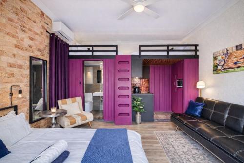 a loft bedroom with a bed and a couch at Balmain Village Retreat AC Free Street Parking City 3km in Sydney