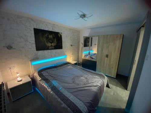 a bedroom with a bed with a blue light at Au refuge de David et Leah in Willer-sur-Thur