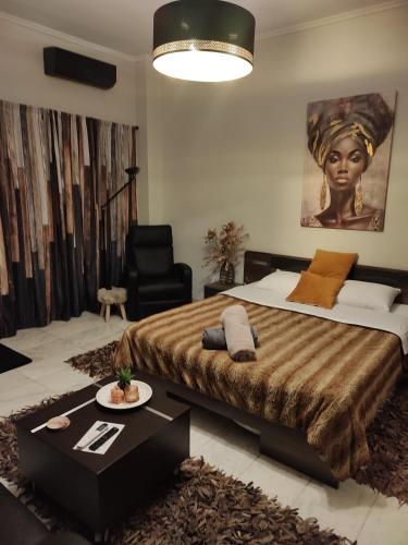 a bedroom with a large bed and a black chair at ViP in Veria
