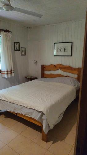 a bedroom with a large bed in a room at Chacra Mariposas in Oberá