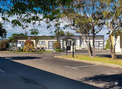 a parking lot in front of a building at Spanish Lady Motel in Napier