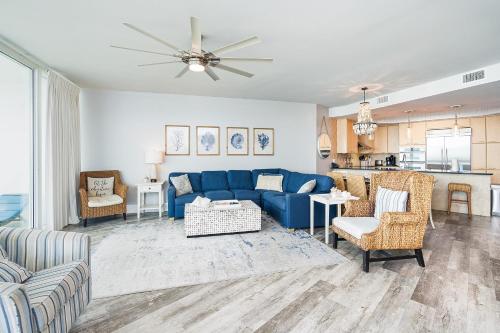 a living room with a blue couch and chairs at Caribe 305C by Youngs Suncoast in Orange Beach