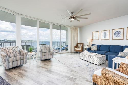 a living room with a blue couch and chairs at Caribe 305C by Youngs Suncoast in Orange Beach