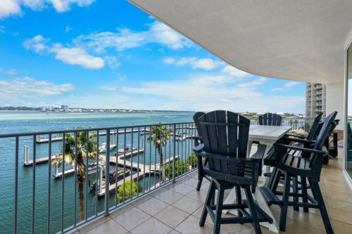 a balcony with a table and chairs overlooking the water at Caribe 305C by Youngs Suncoast in Orange Beach