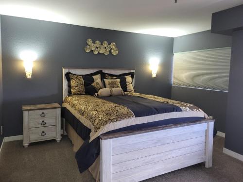 a bedroom with a large bed and a night stand at Comfortable 1 Bed 1 Bath Loft in Uptown Denver in Denver