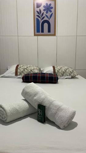 two beds with towels on them in a room at Pousada Rosario in Malhada dos Bois