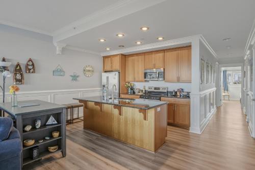 a kitchen with wooden cabinets and a counter top at Oceanfront Condo King Suite & Pet-Friendly Stay in Rockaway Beach