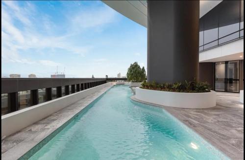 a swimming pool on the side of a building at Queen's Wharf Apartments in Brisbane