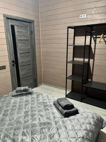 a bedroom with a bed with two pillows on it at Gora vitriv in Slavske