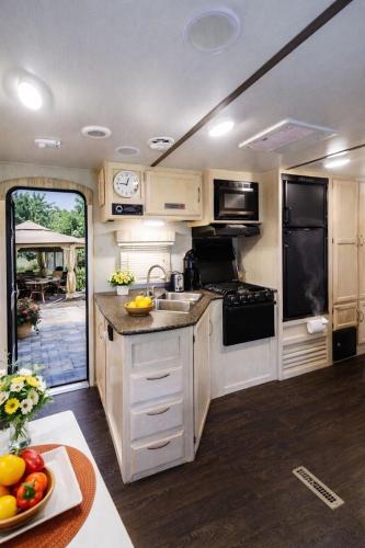 an rv kitchen with a sink and a stove at Sun RV in Trailer park in Naples