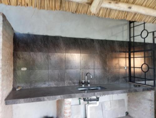 a kitchen counter with a sink in a room at Cabaña don Cencio in San Pedro