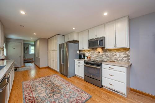 a kitchen with white cabinets and a brick wall at On Deep Creek Time by Railey Vacations in Friendsville