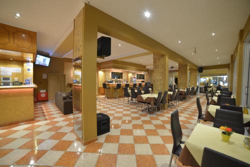 
a large room with a lot of tables and chairs at Angelina Hotel & Apartments in Sidari
