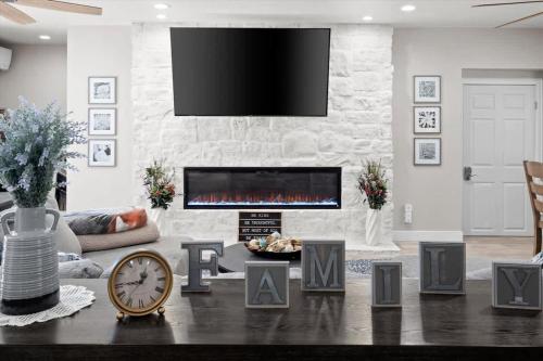 a living room with a fireplace and a tv at Timberland Hideaway in Payson