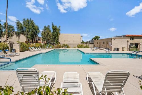 a swimming pool with lounge chairs in a resort at Old Town Elegance in Scottsdale