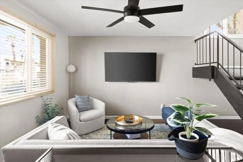 a living room with a couch and a ceiling fan at Old Town Elegance in Scottsdale